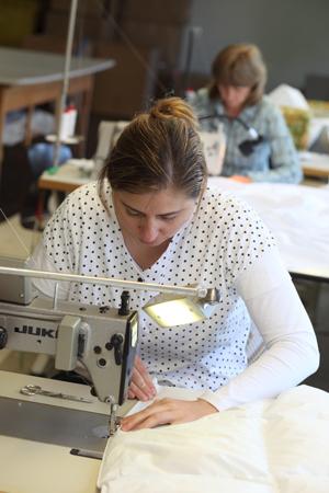 Sorgfältig werden die letzten Schritte zur Produktion der Daunendecke durchgeführt.